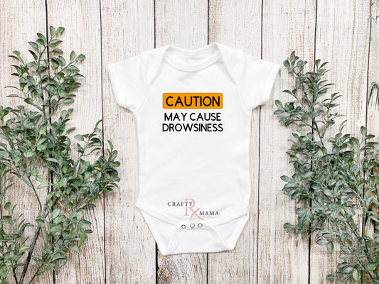 CAUTION May cause drowsiness bodysuit or tee