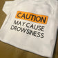 CAUTION May cause drowsiness bodysuit or tee